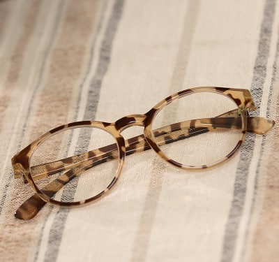 A pair of women's cat-eye glasses with a tortoiseshell frame.
